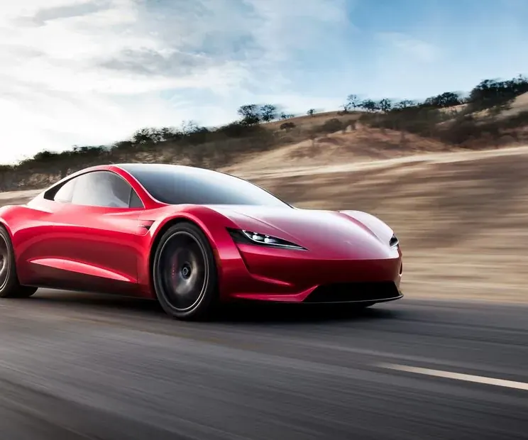 The red next-generation Tesla Roadster prototype on a desert road