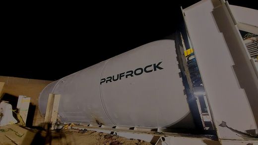 Prufrock tunnel boring machine labeled on the white cylinder at night