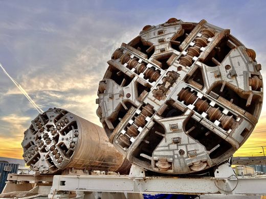 Two Boring Company TBM cutter heads on transport cradles at sunset