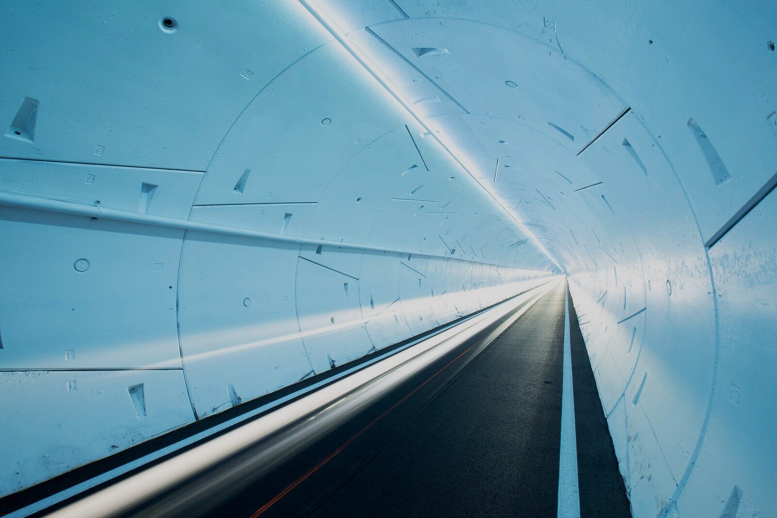 Long exposure of a vehicle moving through a Boring Company tunnel