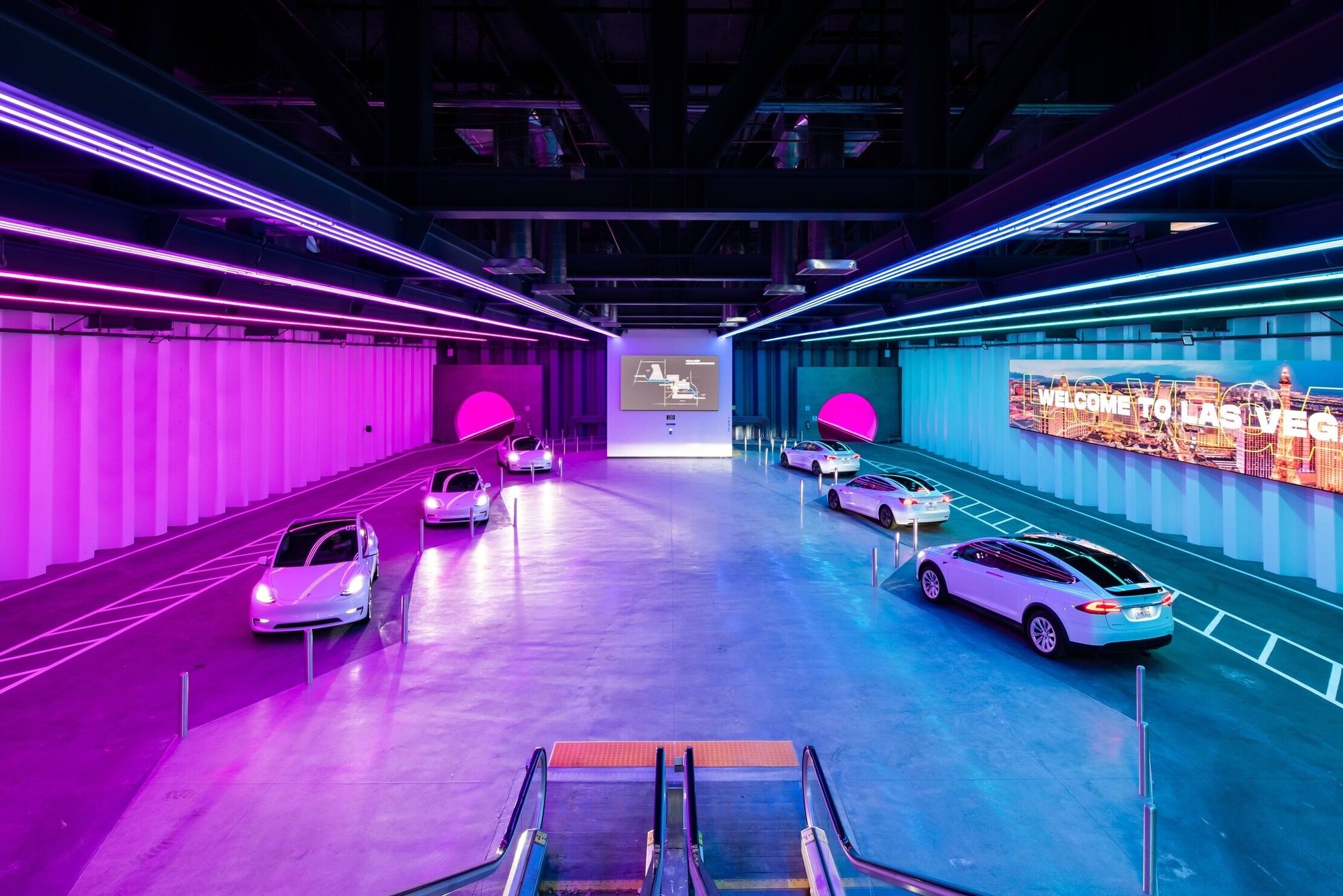 Vegas Loop station with Tesla vehicles under neon lighting