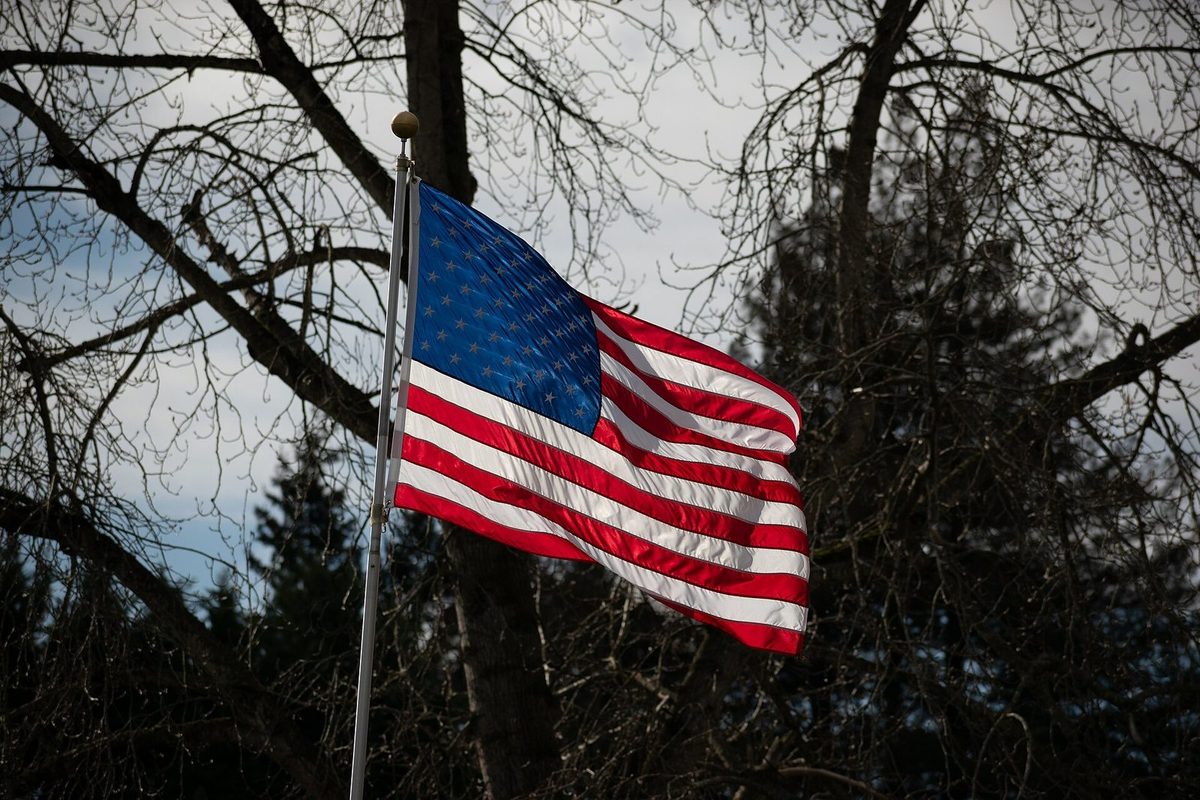 The flag of the United States waving on a flagpole