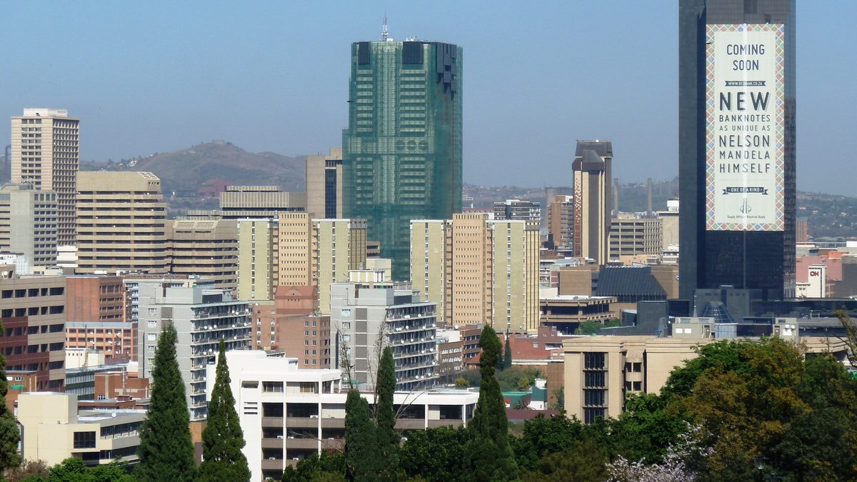 Central Pretoria seen from the Union Buildings, with office towers behind a line of trees