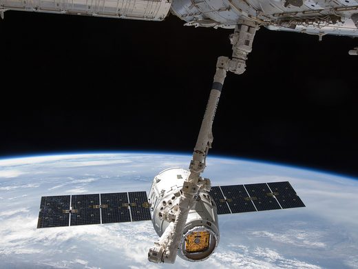 SpaceX's first Dragon held by the space station's Canadarm2 robotic arm in May 2012