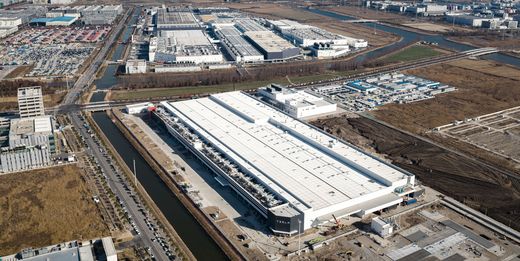 Aerial view of Gigafactory Shanghai with the TESLA logo on the white factory building