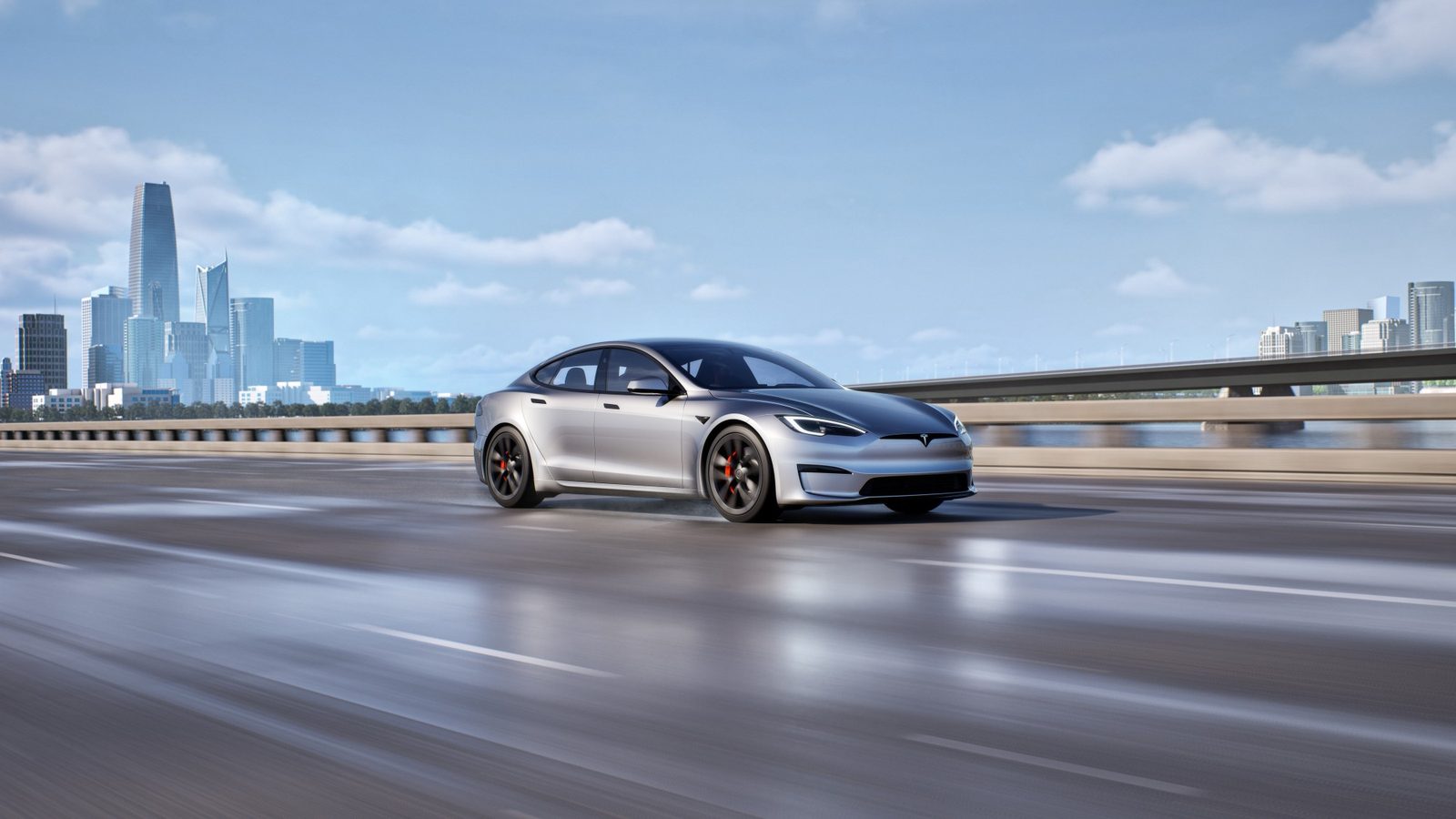Silver Tesla Model S on a bridge with a city skyline behind it