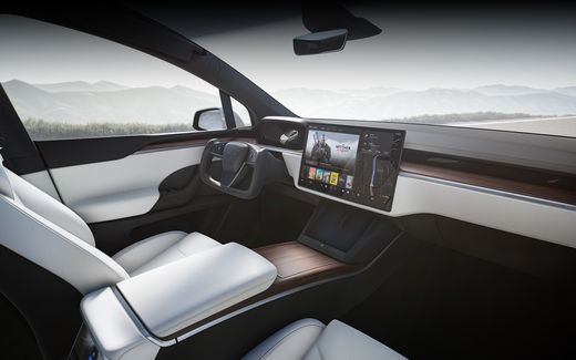 Tesla Model X yoke interior with white seats and a 17-inch landscape touchscreen