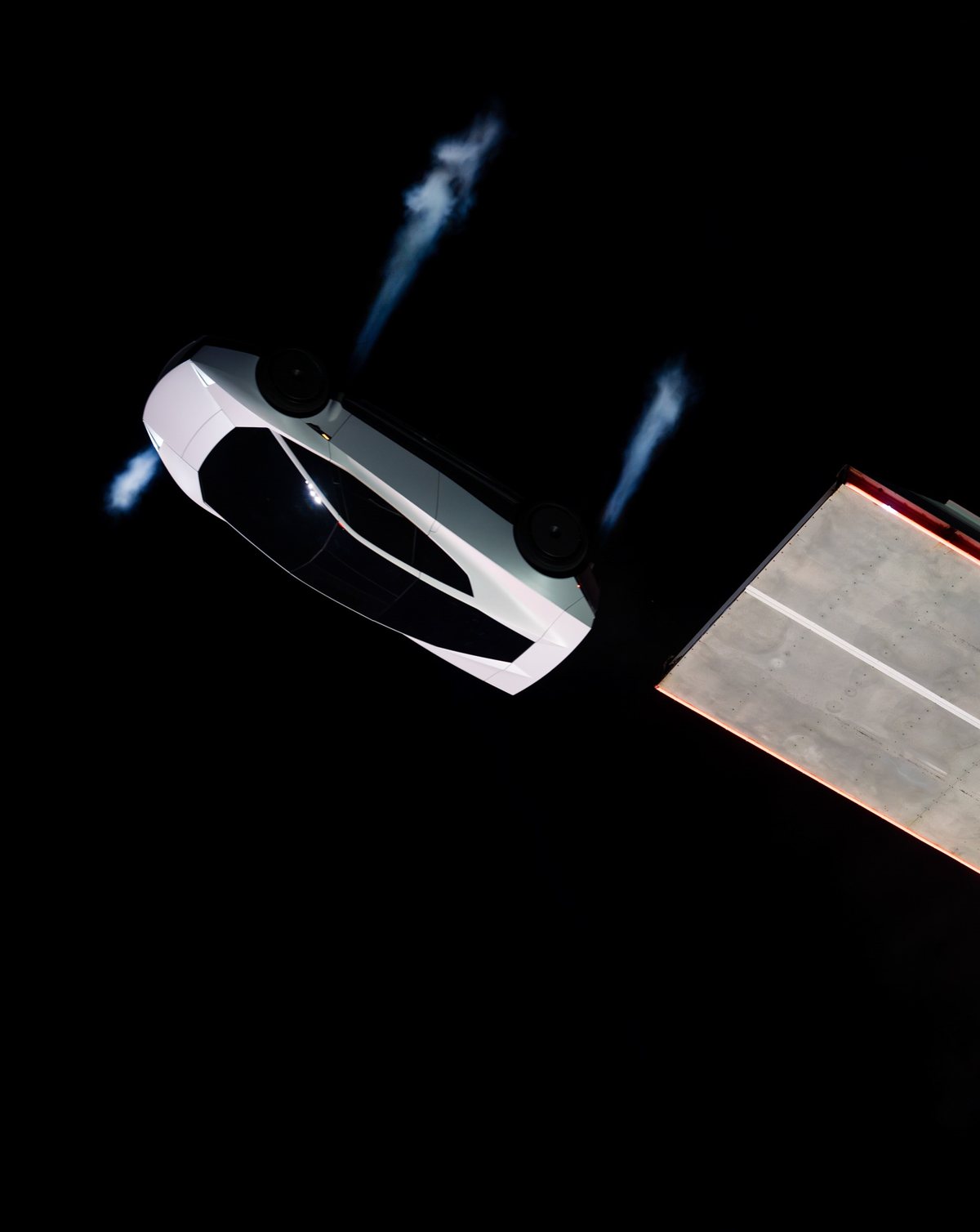 Upside-down 2026 Tesla Roadster leaving the top of a curved ramp with its thrusters firing