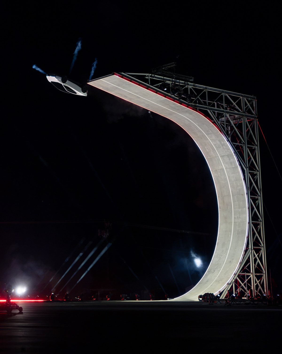 The giant curved steel ramp at the reveal, with the Roadster at its top