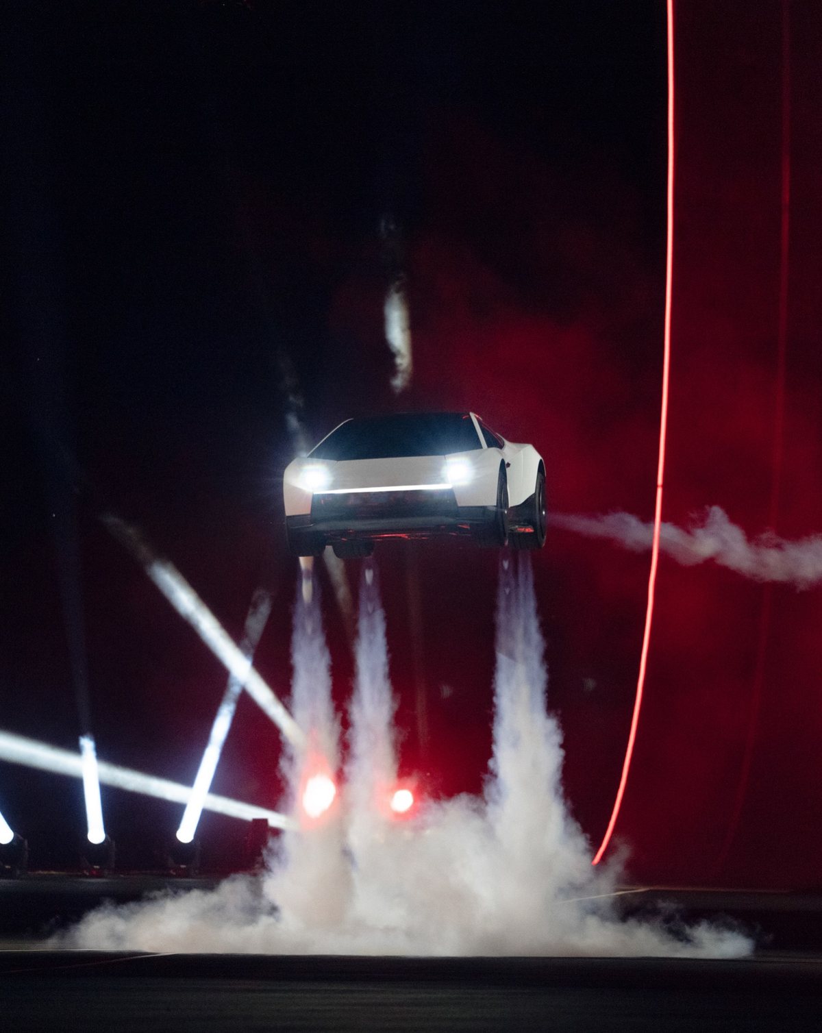 The 2026 Tesla Roadster seen head-on, coming down on columns of thruster gas