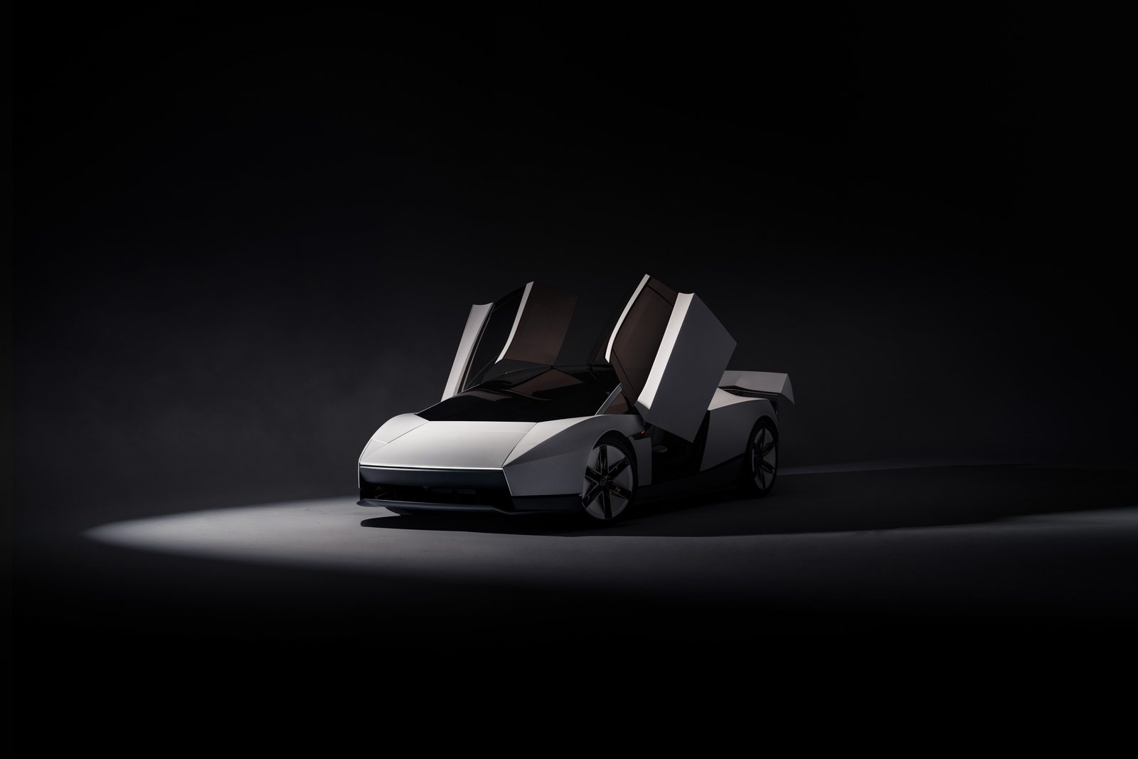 Front three-quarter view of the 2026 Tesla Roadster in a dark studio with both doors raised